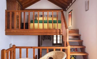 a small , cozy room with wooden furniture and a balcony with a table and chairs at Casa Palma