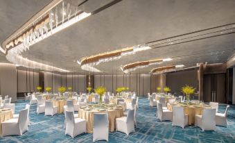 The ballroom is decorated and set up with tables and chairs for an event at Crowne Plaza Shanghai Hongqiao