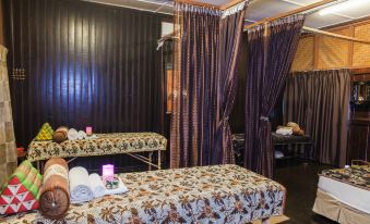 a room with two massage tables , one on the left and one on the right , covered with towels at Mutiara Taman Negara