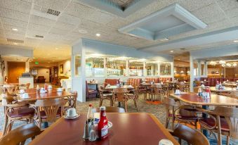 a large dining room with tables and chairs arranged for a group of people to enjoy a meal together at Siegel Select Bartlett