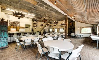 a large room with several round tables and chairs arranged for a group of people to gather and socialize at North Texas Jellystone Park