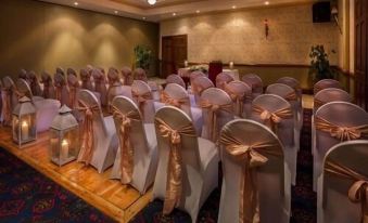 a room set up for a wedding or banquet , with chairs arranged in rows and a table in the center at Breffni Arms Hotel