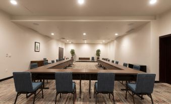 a large conference room with a long table , chairs , and framed pictures on the wall at Four Points by Sheraton Puntacana Village