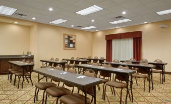 a large , empty conference room with rows of chairs and tables set up for meetings or events at Homewood Suites by Hilton Rochester - Victor