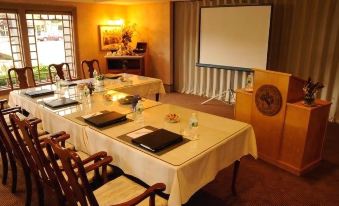 a conference room set up for a meeting , with chairs arranged in a semicircle around a table at The Clarkson Inn