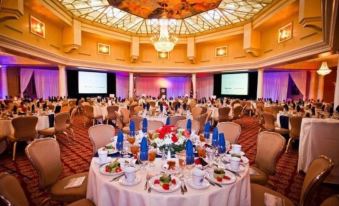a large banquet hall filled with tables and chairs , ready for a formal event or a formal gathering at Safety Harbor Resort & Spa, Trademark Collection by Wyndham
