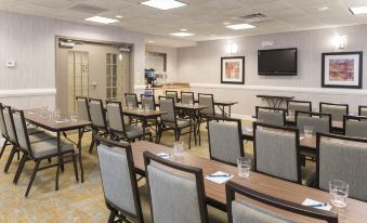 a dining room with tables and chairs arranged for a group of people to enjoy a meal together at Homewood Suites by Hilton Bloomington