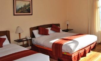a hotel room with three beds , two of which are twin beds and one is a double bed at Copacabana