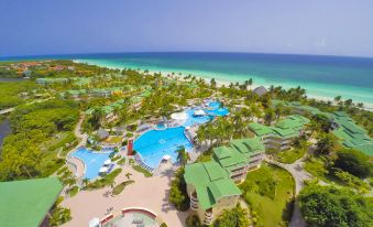 aerial view of a resort with multiple swimming pools , beaches , and lush greenery in the background at Tryp Cayo Coco