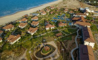an aerial view of a residential area near the ocean , with multiple houses and a small park at Tui Blue Nam Hoi An