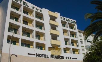 "a large hotel building with a sign that reads "" hotel francis "" prominently displayed on the side of the building" at Hotel Francis