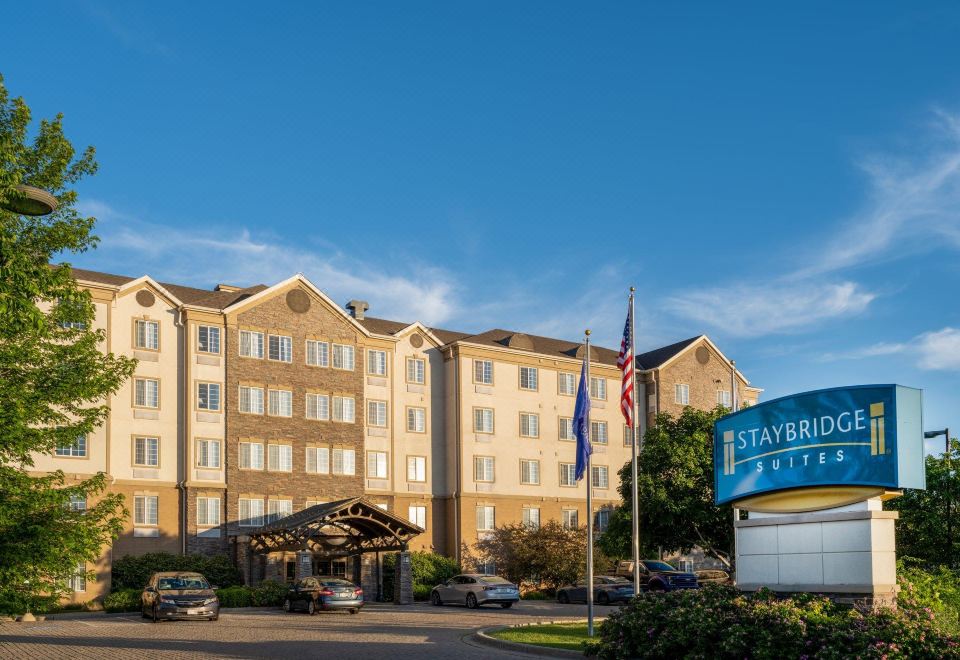 a hotel with a large parking lot in front of it , where people are waiting to be seen at Staybridge Suites Milwaukee Airport South