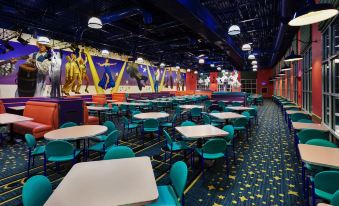 a large , brightly lit dining room with multiple tables and chairs arranged for a group of people to enjoy a meal together at Disney's All-Star Music Resort