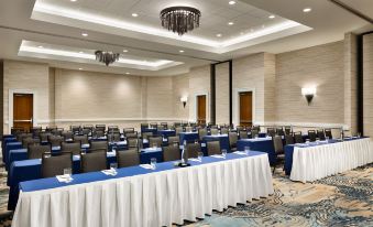 a conference room with multiple tables and chairs , all set up for an event or meeting at Embassy Suites by Hilton Monterey Bay Seaside