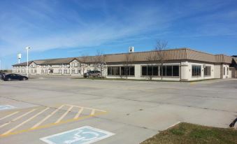 a large parking lot in front of a building , with multiple cars parked on the lot at Country Inn & Suites by Radisson, Sidney, NE