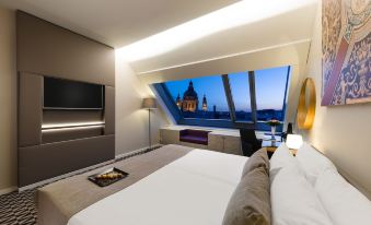 a luxurious bedroom with a large bed , a flat - screen tv , and a view of the city skyline at Hotel Moments Budapest