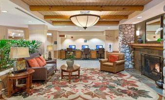 a hotel lobby with a reception desk , couches , and chairs , creating a comfortable and inviting atmosphere at Hilton Vacation Club Lake Tahoe Resort South