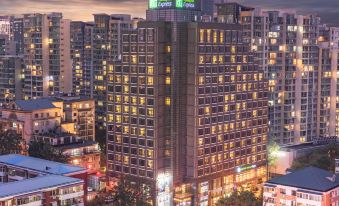 The city is illuminated at night with buildings glowing in blue and white colors at Holiday Inn Express Beijing Dongzhimen