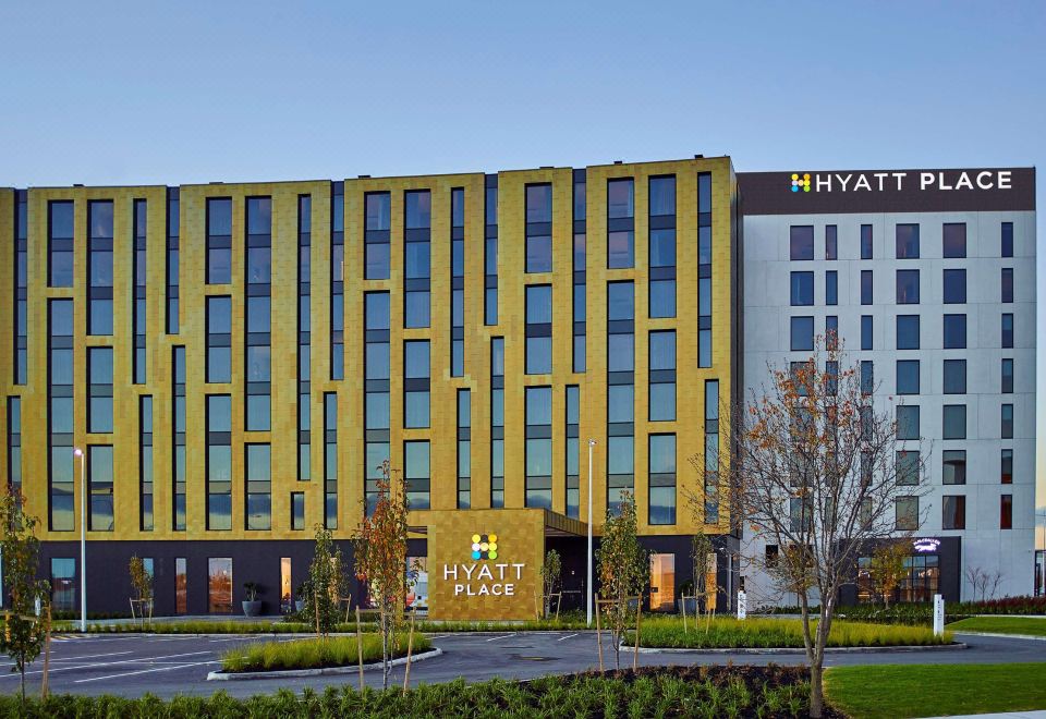 "a large hotel with a yellow facade and the words "" hyatt place "" displayed on the side" at Hyatt Place Melbourne Essendon Fields