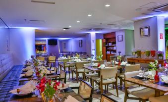a large dining room filled with tables and chairs , ready for guests to enjoy a meal at San Marino Suites Hotel by Nobile
