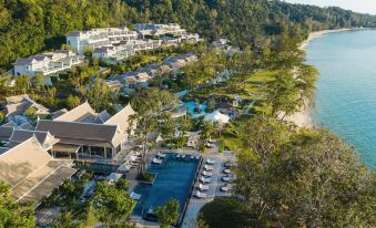an aerial view of a resort on a tropical island , with a beach visible in the background at Banyan Tree Krabi