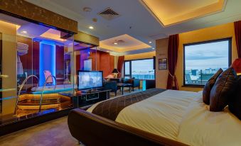 a luxurious hotel room with a king - sized bed , a flat - screen tv , and a pool table at ABC Hotel