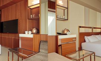 a hotel room with a bed , two sinks , and a kitchen area with a sink at Candeo Hotels Omiya