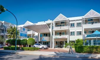 "a white building with a car parked in front and a sign that says "" capriccio "" on the right side" at Broadwater Resort Como