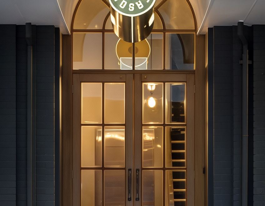 a starbucks store entrance with a large logo above the door , creating a unique and inviting atmosphere at The Chamberson