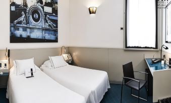 a hotel room with two beds , a window , and a desk , decorated in white and blue colors at Hotel Milano