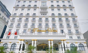 "a large white building with the name "" pierre hotel "" on it , surrounded by palm trees and other greenery" at Phoenix Hotel