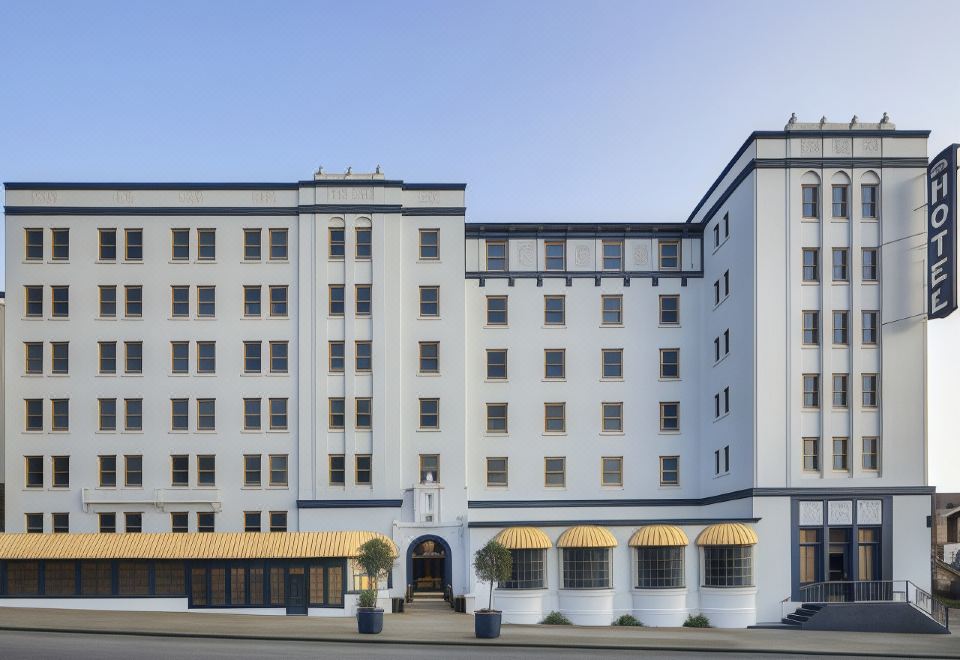 "a white building with a yellow awning and a sign that says "" leisure inn "" is shown" at Graduate Berkeley