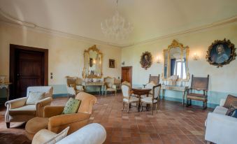 a large , elegant living room with multiple pieces of furniture , including a couch , chairs , and a dining table at Castello di Semivicoli