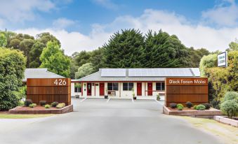 "a building with a sign that says "" 4 2 6 "" and the number 4 2 6 , surrounded by trees" at Black Forest Motel