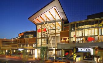 a modern shopping mall with a large glass building and red lanterns hanging from the roof at DoubleTree by Hilton Seattle Airport