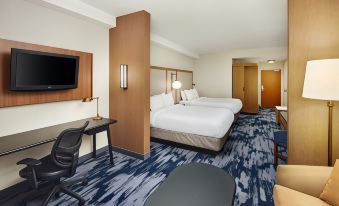 a modern hotel room with a large bed , desk , and chairs , as well as a tv and window at Fairfield Inn & Suites Worcester Auburn