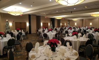 a large banquet hall with multiple tables and chairs set up for a formal event at DoubleTree by Hilton Hotel Oak Ridge-Knoxville