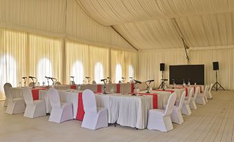 a large dining room with multiple tables and chairs set up for a special event at Sweetwaters Serena Camp
