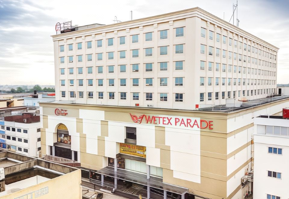 "a large white building with a red sign that reads "" wetex parade "" prominently displayed on the side" at Classic Hotel Muar
