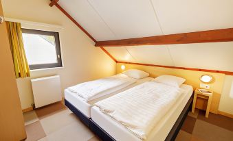a room with two beds , one on top of the other , in a small space at Sunparks Kempense Meren