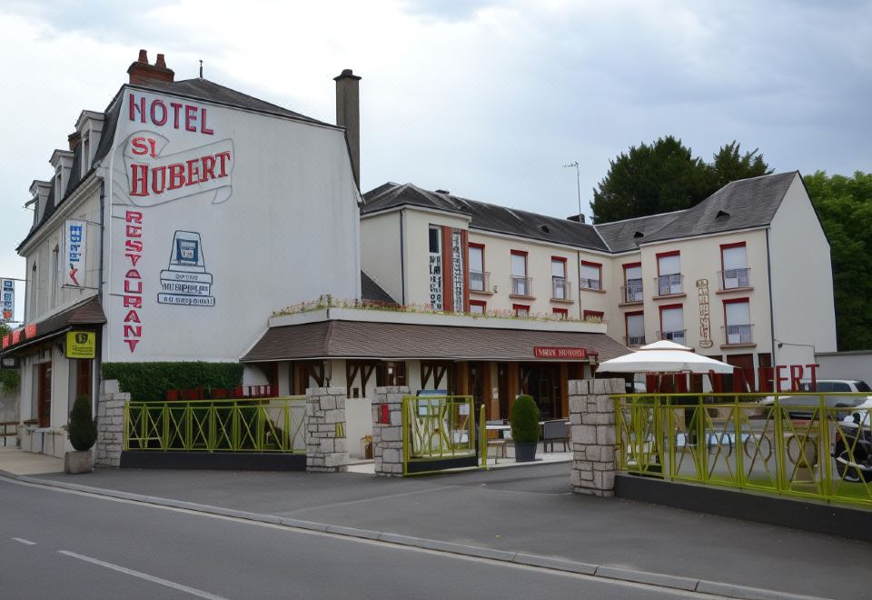 "a hotel with a large sign that says "" hotel la hubert "" is shown next to a street" at Hotel Saint-Hubert