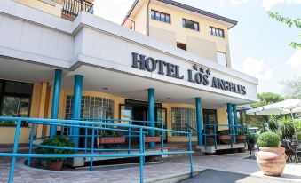 a hotel building with a large sign above the entrance , indicating that it is a hotel at Hotel Los Angeles