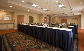 a large conference room with several rows of chairs arranged in a semicircle , creating an intimate setting for a meeting at Hilton Garden Inn Jackson/Madison
