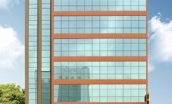 a modern building with multiple windows , each with a different color and design , reflecting a cityscape in its glass facade at Hallmark Regency Hotel - Johor Bahru