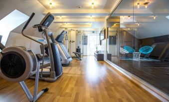 a well - equipped gym with various exercise equipment , such as treadmills , elliptical machines , and weight machines at Clarion Collection Hotel Carlscrona