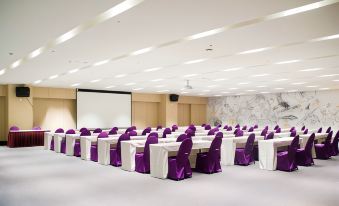 a large conference room with rows of chairs arranged in a semicircle , ready for a meeting or event at Hotel Cham Cham