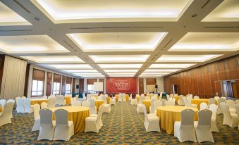 a large banquet hall with tables and chairs set up for a formal event , possibly a wedding reception at Classic Hotel Muar