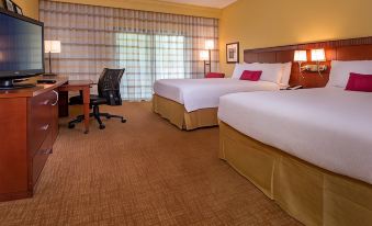 a hotel room with two beds , one on the left and one on the right side of the room at Courtyard Richmond West