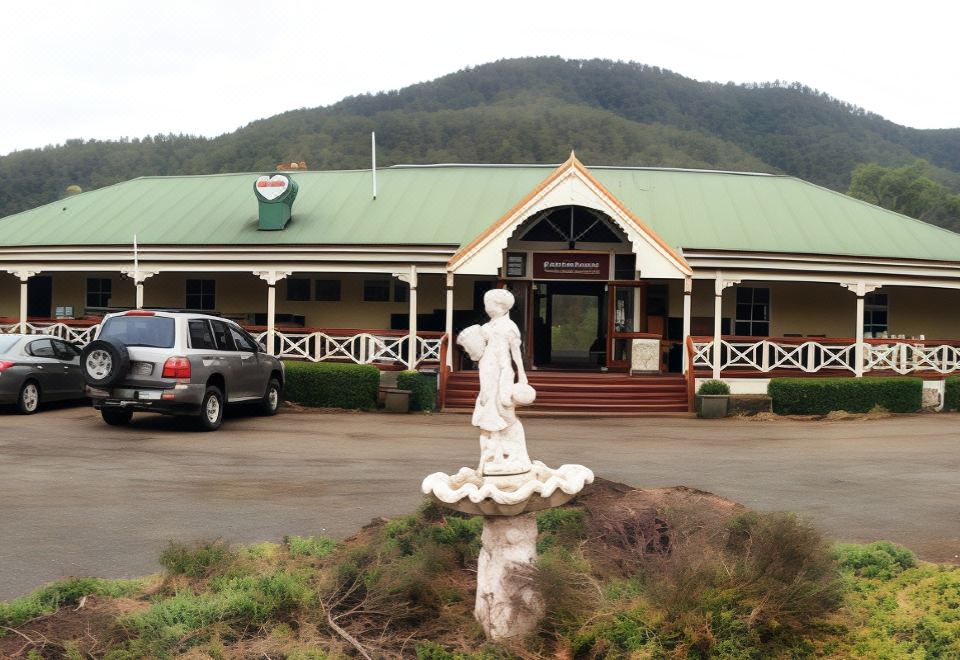 a building with a statue in front of it , surrounded by cars and other vehicles at Bestbrook Mountain Farmstay