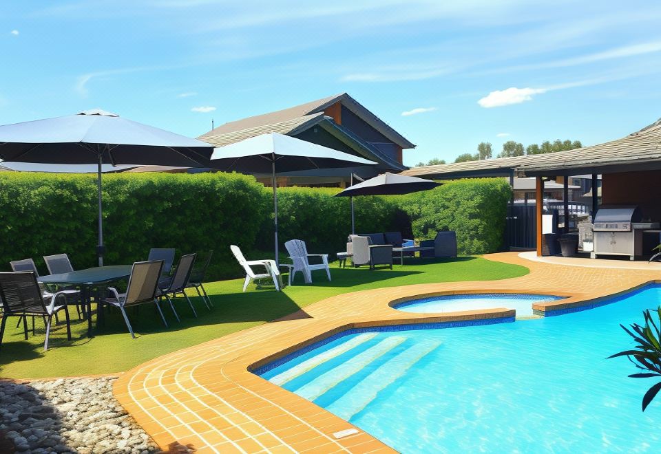 a swimming pool surrounded by a patio area with lounge chairs and umbrellas , providing a relaxing atmosphere at The Heritage Bendigo